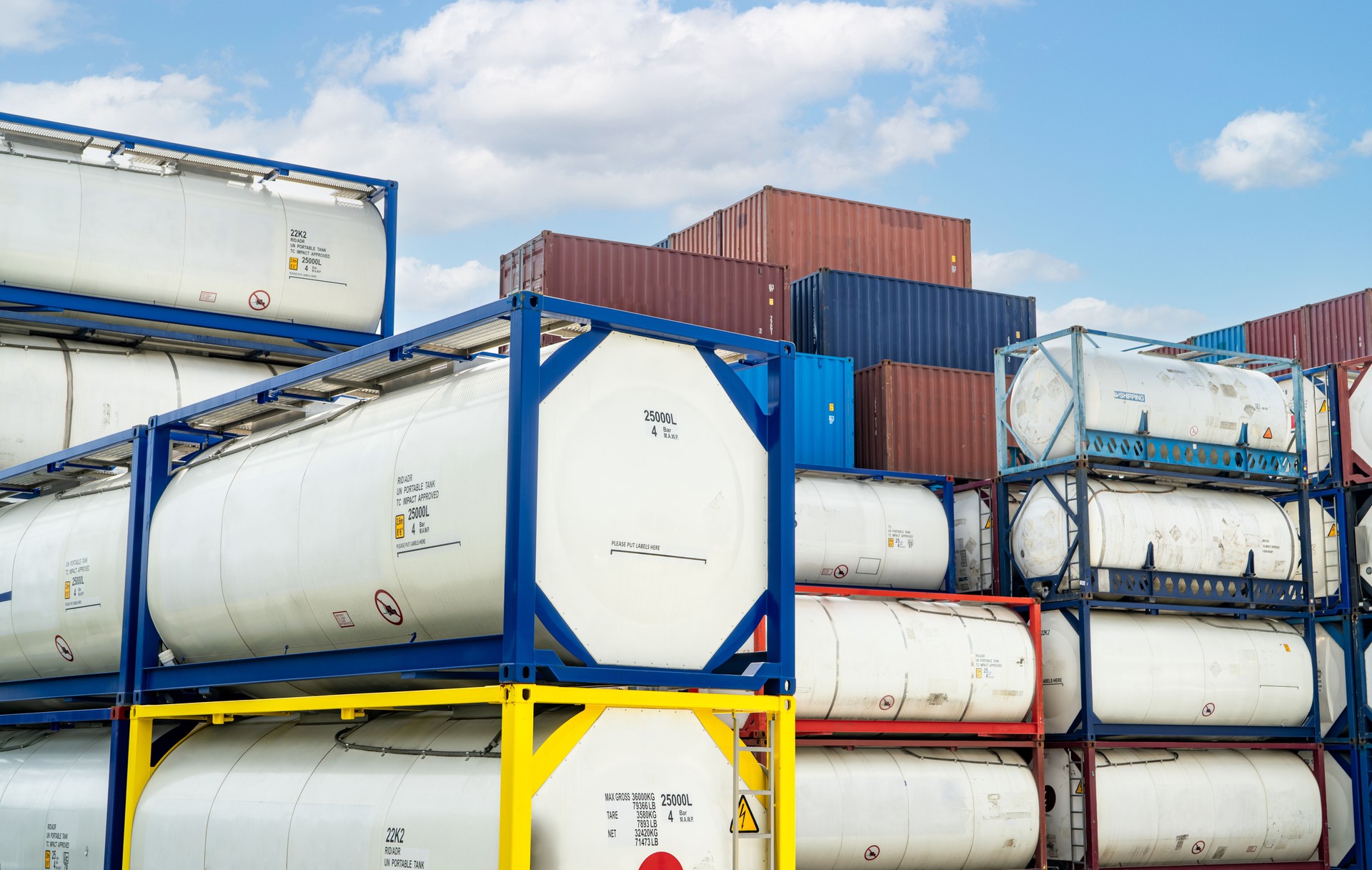 Chemical tank container. ISO tank container for chemical delivery. Bulk liquid transport. Chemical company. Container freight area. Global logistics business. Chemical container for truck transport.